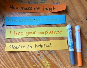 Strips of coloured paper with compliments